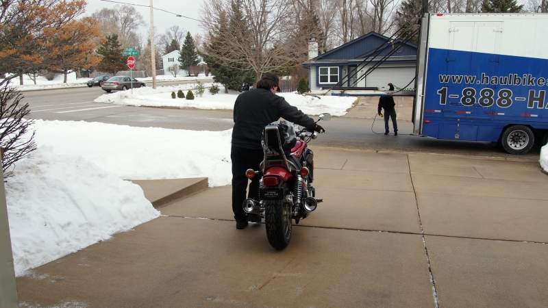 Curtis taking the bike down the driveway for the last time.