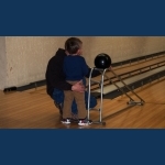 Dad consoling Jakob after his finger was pinched by the bowling ball